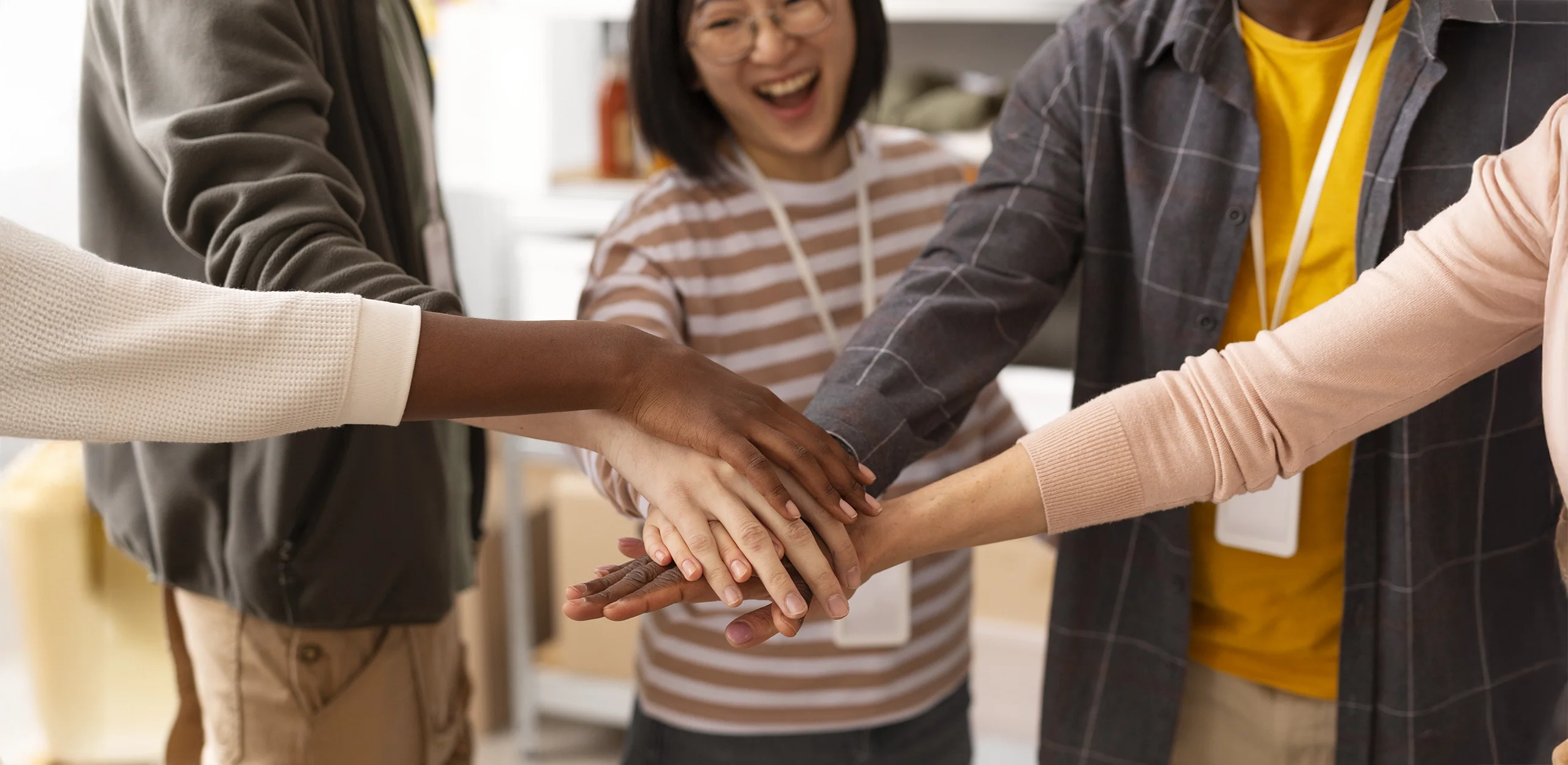 Students putting their hands into the middle of the circle.