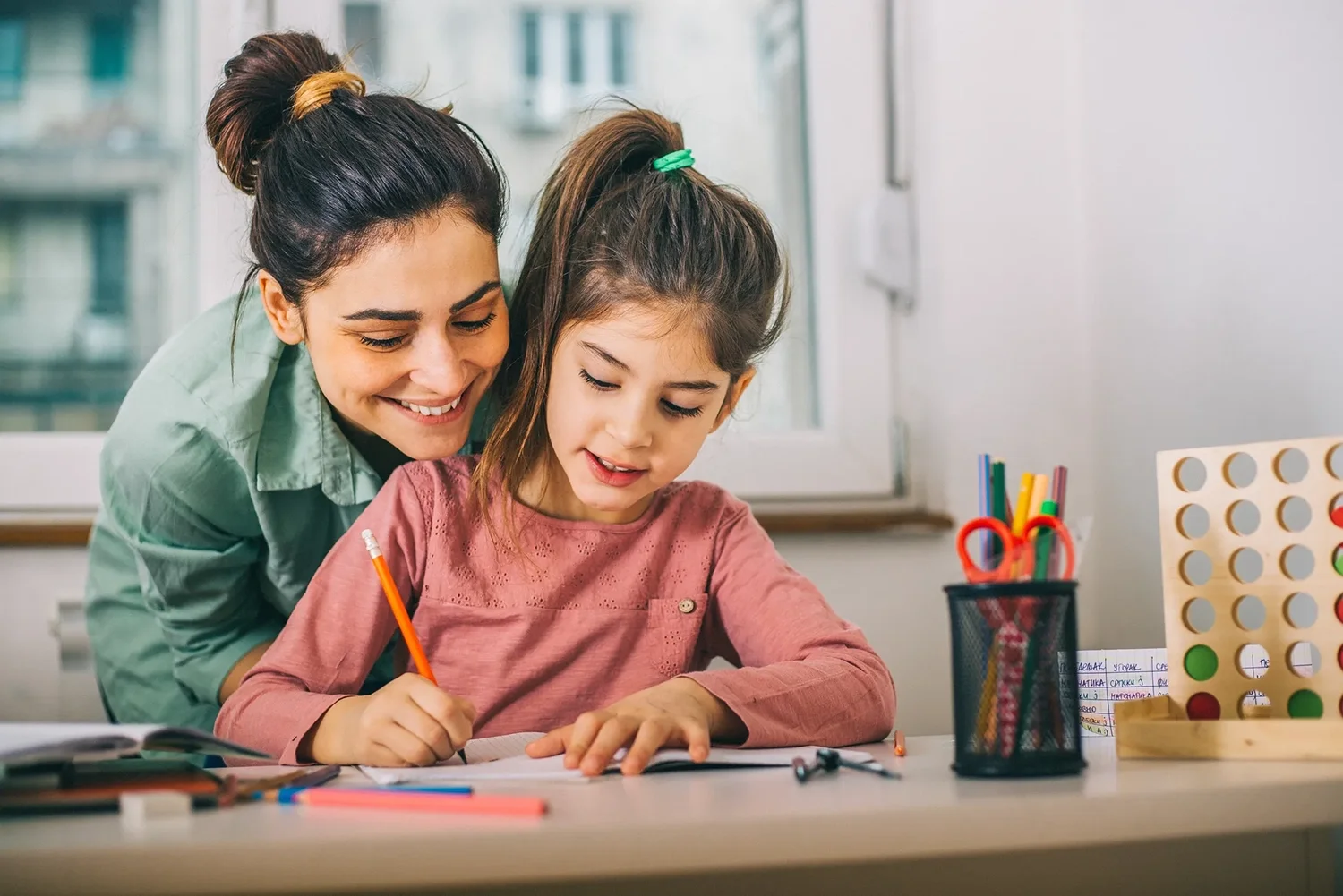 Mother working on school work with daughter.
