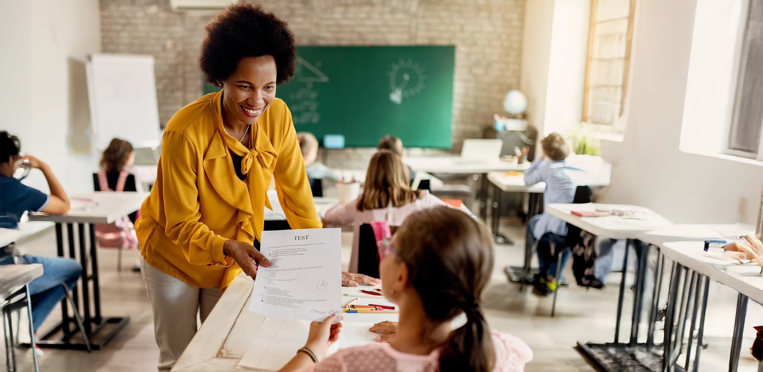 Teacher handing test back to student